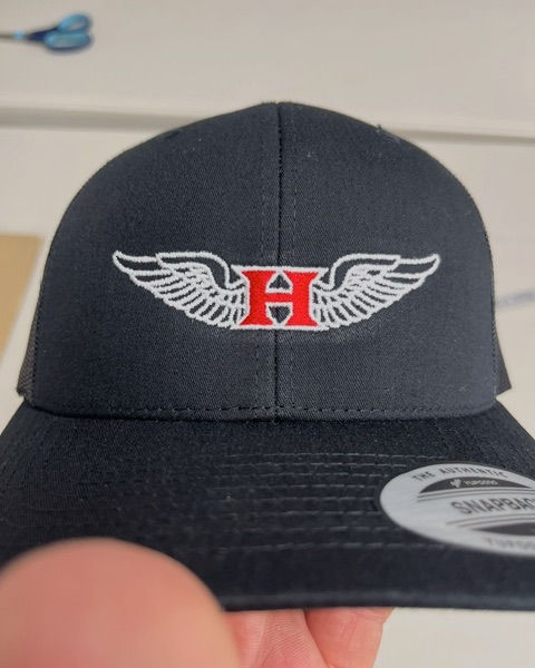 Winged H logo embroidered in white and red on a black Yupoong snapback